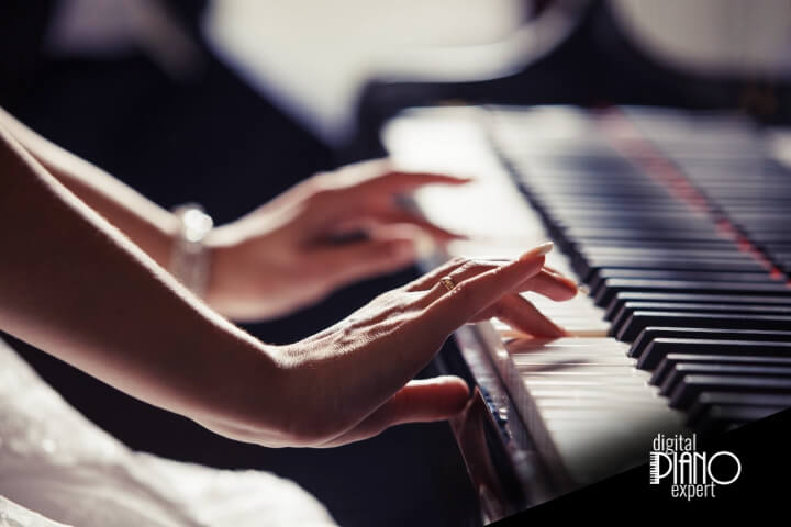 woman playing the piano using both hands