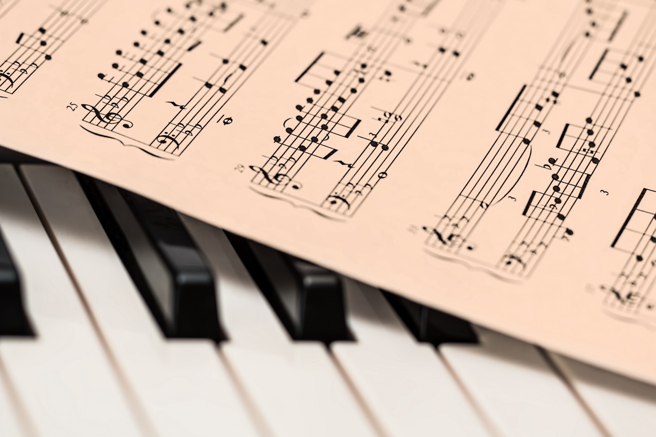 sheet music on top of piano keyboard