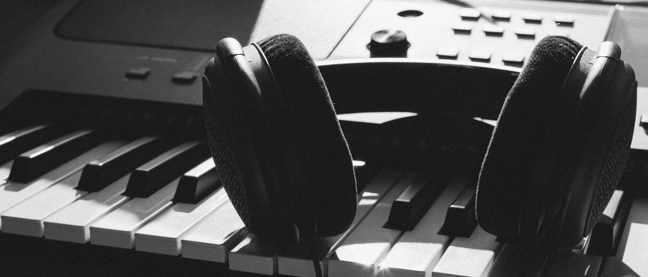 Keyboard and headphone in black and white photo 